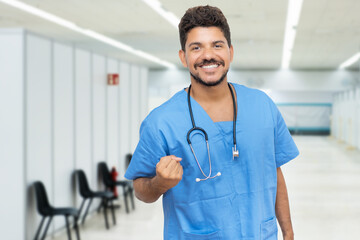 Laughing hispanic male doctor is ready for vacinating patients