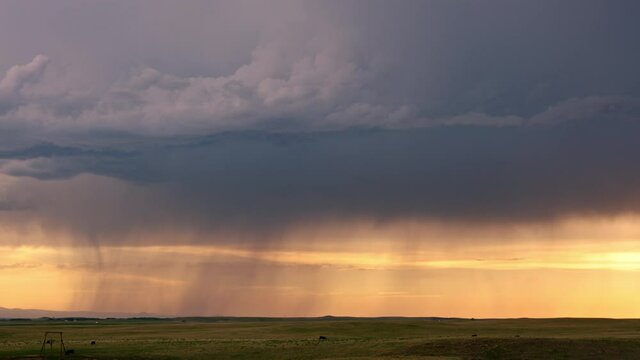 Timelapse of rain storm moving over the horizon in South Dakota at sunset.