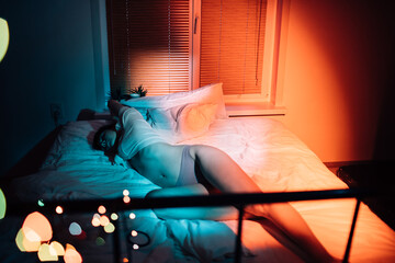 Calm woman lying on bed in bedroom
