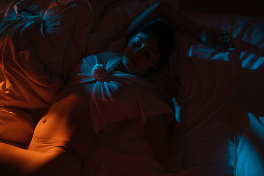 Peaceful woman sleeping on bed

