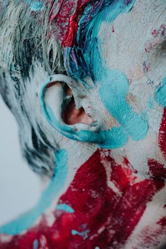 Strokes of colorful paint around ear
