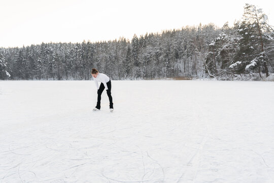 Figure Skater Resting At Frozen Lake