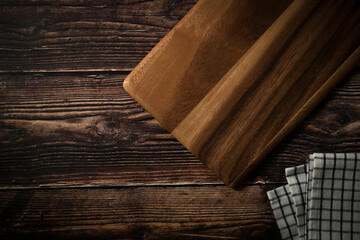 Obraz na płótnie Canvas wooden cutting board on the dark wood kitchen