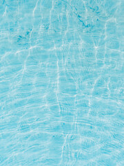 The smoothness of the water in the lake, ripples from the wind. Shades of blue, natural background.	