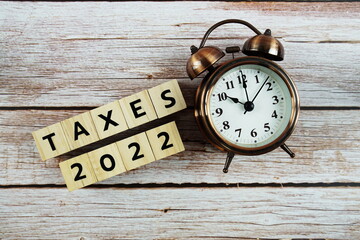Taxes 2022 alphabet letter on wooden background