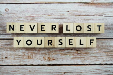Never Lost Yourself word alphabet letters on wooden background