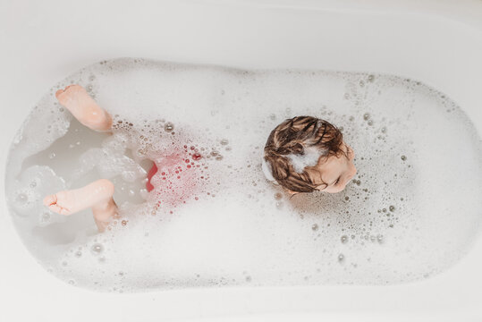 Toddler swimming in bubble bath