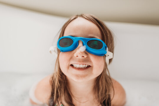 Girl with goggles enjoying bath time