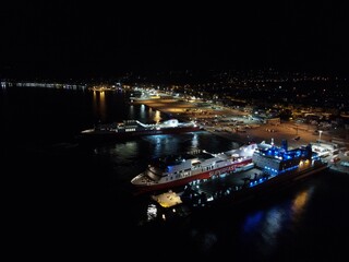 Fototapeta na wymiar Aerial Night View Of Cruise Ships In Port Station Of Igoumenitsa City In Greece