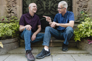 Elderly gay coule talking outdoors