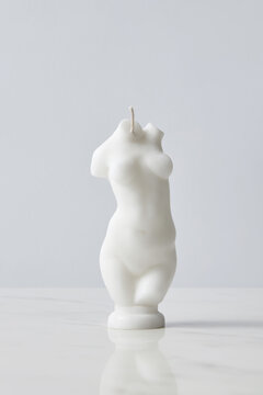 Closeup of candle with female shape
