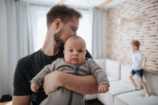 Young father with his newborn son