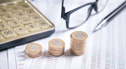Eyeglasses, coins, calculator, pen on financial documents. Business. Finance