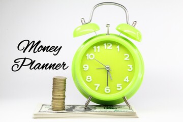 alarm clocks, coins, banknotes and money planner words