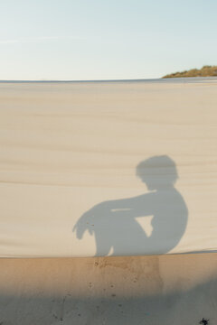 Female Silhouette On The Wind Breaker At The Beach