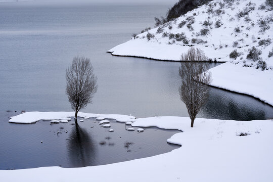 Snowy mountains and lake in winter highlands