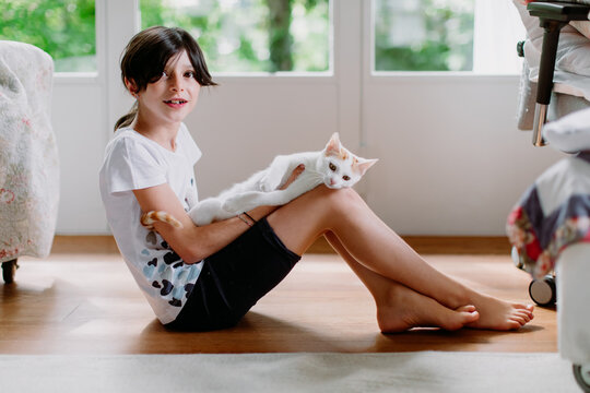Teen-ager with kitty cat on her lap