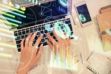 Double exposure of woman hands working on computer and data theme hologram drawing. Top View. Technology concept.