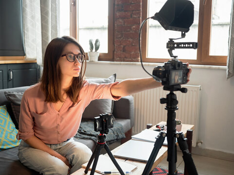 Woman recording video at home