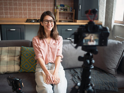 Woman recording video at home