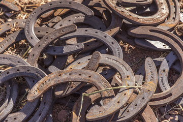 Horseshoes discarded in a pile previously worn by the cowboy's horses make an interesting image of shapes, shadows and a remembrance for the old western days when horses were the main mode of transpor