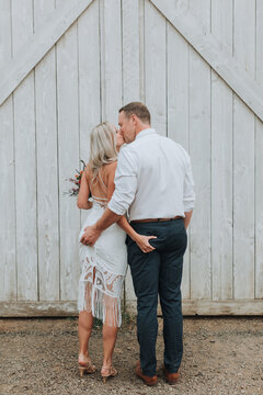 Flirty Bride and Groom Squeezing Each Other's Butts at Wedding