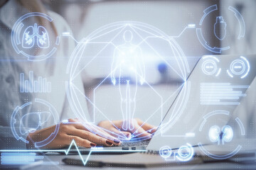 Double exposure of woman hands typing on computer and general theme hologram drawing. Education concept.