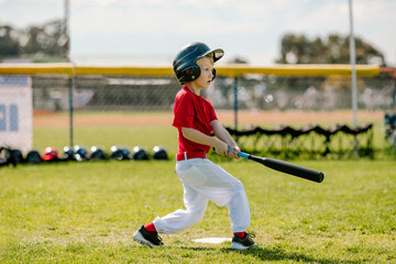 Young boy playing his first little league game