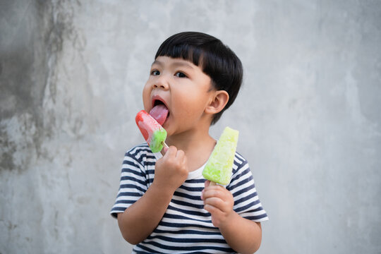 Asian boy eating ice cream
