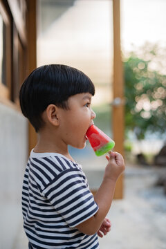 Asian boy eating ice cream
