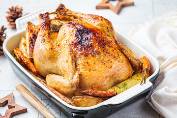 Christmas baked whole chicken stuffed with thyme, lemon and vegetables.