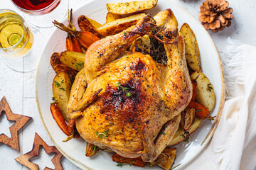 Christmas baked whole chicken stuffed with thyme, lemon and vegetables.