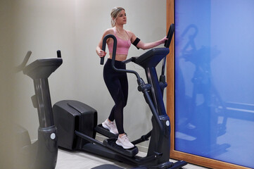 Young woman on an elliptical trainer