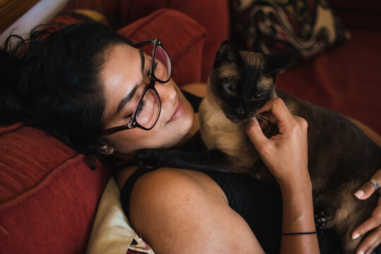 Woman relaxing with her cat in the couch