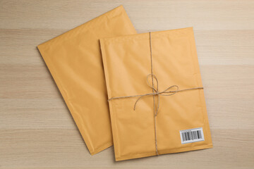 Padded envelopes on wooden background, flat lay