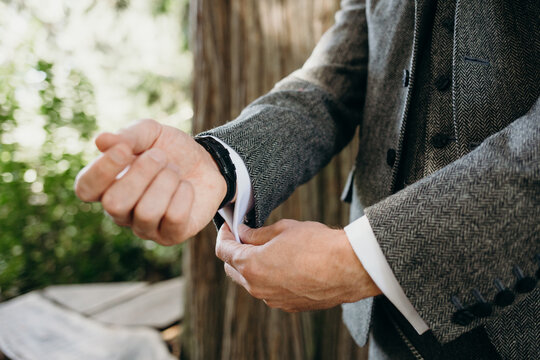 Groom Putting on Cufflinks before Wedding