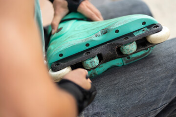 person repairing inline skates damaged by time of use