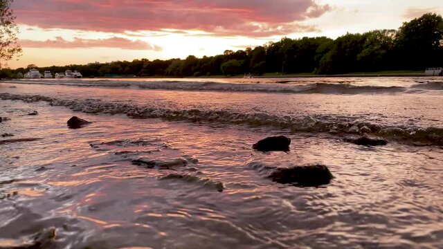 The river bank at sunset in summer. Summer landscape on the river bank. 4K video.