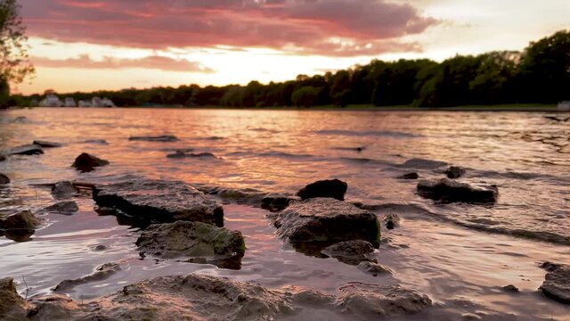 The river bank at sunset in summer. Summer landscape on the river bank. 4K video.