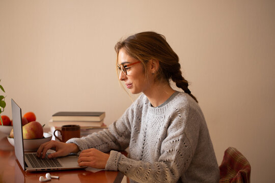 Young woman girl doing homework in her home