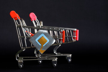 Two supermarket carts with RFID tag transponder. The concept of using wireless RFID technologies in...