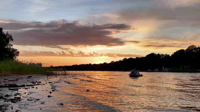 The river bank at sunset in summer. Summer landscape on the river bank. 4K video.