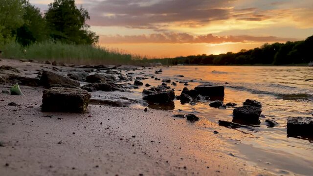 The river bank at sunset in summer. Summer landscape on the river bank. 4K video.