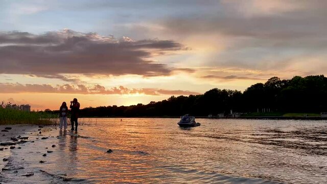 The river bank at sunset in summer. Summer landscape on the river bank. 4K video.