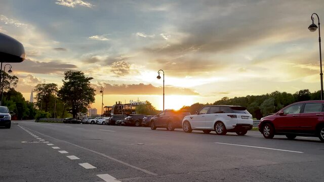 Sunset of the day on the streets of the city. City roads on the background of the sun at sunset. 4K video of Russian highways.