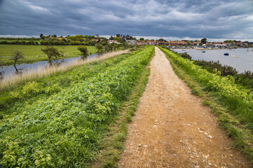 Fototapeta na wymiar Path along the river in Burnham Overy Staithe, Norfolk, England
