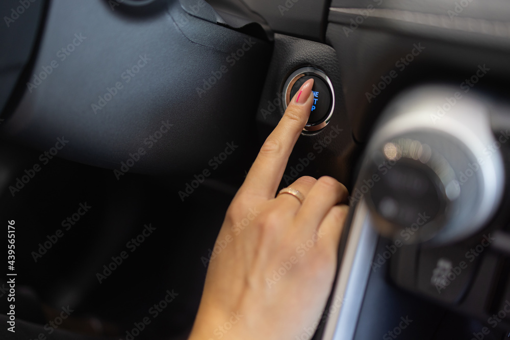 Canvas Prints Female hand with start key inside car.