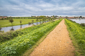 Fototapeta na wymiar Path along the river at Burnham Overy Staithe, Norfolk, England