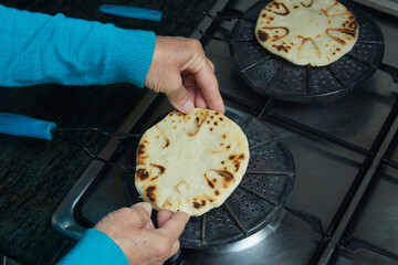 Roasting corn arepas on a grill. Typical food of Colombia