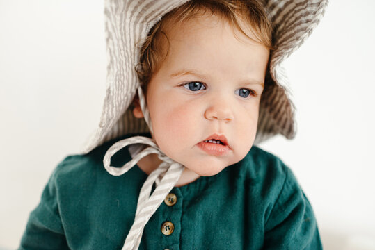 Close up of little girl wearing a sun hat 
